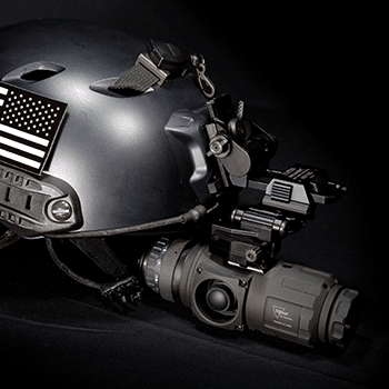 Tactical helmet shown with a Trijicon IR-Patrol thermal monocular mounted to it with a helmet mount.