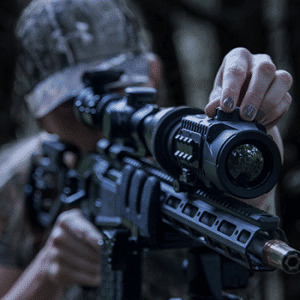 Man shown looking through a Pulsar Krypton FXG50 mounted to an AR-15 style rifle.
