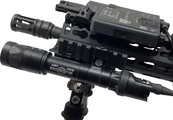 Photo of a black US Night Vision DesignateIR shown mounted to the front of an AR-15 rifle.